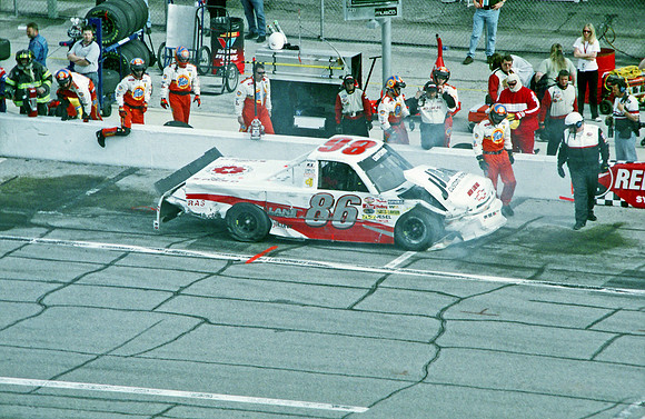 < img src= "Lance Hooper #86 in pit, wrecked.JPG" alt= "2003 NASCAR Craftsman Truck Series, Florida Dodge Dealers 250, at Daytona Speedway" >
