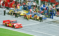 < img src= "Bobby Hamilton #4, Mike Wallace #52, & Travis Kvapil #16 pitting.JPG" alt= "2003 NASCAR Craftsman Truck Series, Florida Dodge Dealers 250, at Daytona Speedway" >